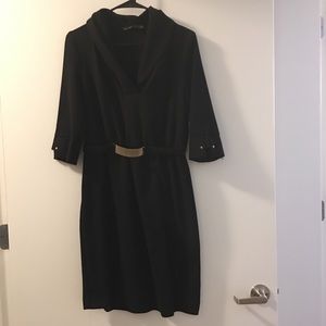 Above knee black dress with gold details.